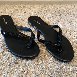 Aldo flat thong . Black with sparkles on thong. Never worn.
